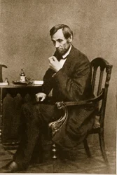 Abraham Lincoln sitting at a desk in the Washington Gallery, May 1861